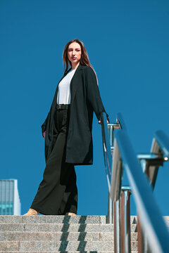The white beatiful girl stairs at you against the blue sky