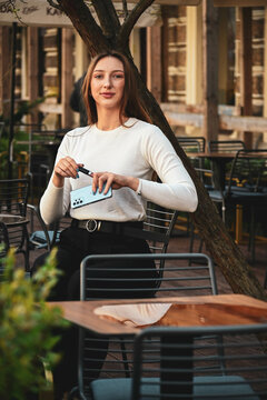 The white beautiful girl up sitting in the caffe outside