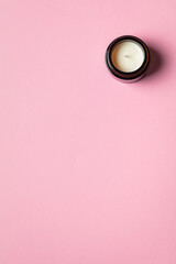 Aroma candle on pink background. Fragrance candle close up and abstract. Zen and relaxed lifestyle.