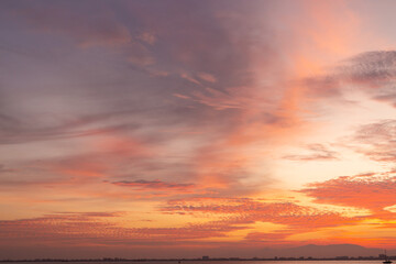 Colourful sunset sky. Full frame view of wispy colourful clouds up in the sky during sunrise or sunset hour. Sky replacement asset.