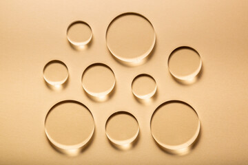 Abstract Transparent Arcyllic Shape Bubbles on Light Brown Background. Light and shadow effect
