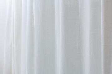 A view of a sheer white curtain diffusing the exterior sunlight, as a background.
