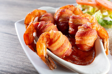 A view of a bowl of bacon-wrapped shrimp.