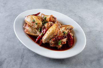 A view of a plate of Chinese fried chicken wings.