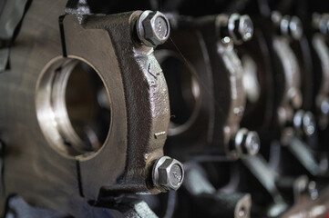 Close-up of a disassembled, engine, part of the automatic transmission box of a car on a machine in a garage or repair factory station for repair or maintenance. Detail. Close up view