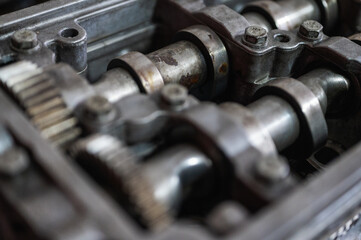Close-up of a disassembled, engine, part of the automatic transmission box of a car on a machine in a garage or repair factory station for repair or maintenance. Detail. Close up view
