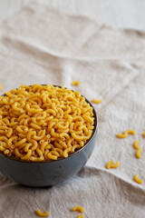 Bowl of Dry Organic Macaroni Elbow Pasta, Ready to be Cooked. Copy space.