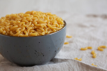 Bowl of Dry Organic Macaroni Elbow Pasta, Ready to be Cooked. Copy space.