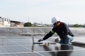 technician inspecting solar panels on factory roof Check and maintain the solar panel roof A team of technicians installing solar panels on the roof of a high-rise building