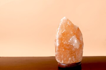 Himalayan salt lamp with the ability to ionize the air on a blue background