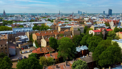 Riga Cityscape Spring Aerial Top View , Town, Latvia. Sunny Day Building Rooftops. Riga Skyline, Latvia, City Center, Teika, Purvciems in the Background. Architecture of the Downtown.