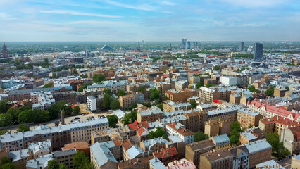 Riga Cityscape Spring Aerial Top View , Town, Latvia. Sunny Day Building Rooftops. Riga Skyline, Latvia, City Center, Teika, Purvciems in the Background. Architecture of the Downtown.