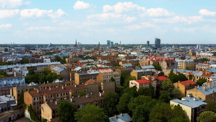 Fototapeta na wymiar Riga Cityscape Spring Aerial Top View , Town, Latvia. Sunny Day Building Rooftops. Riga Skyline, Latvia, City Center, Teika, Purvciems in the Background. Architecture of the Downtown.