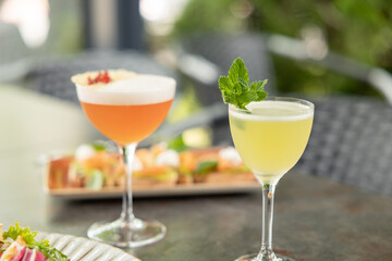 Different delicious summer cocktails on grey table in bar