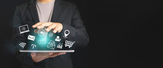 Businessman using tablet with virtual to target customer. notification social multimedia icons internet connection application digital network marketing online communication.