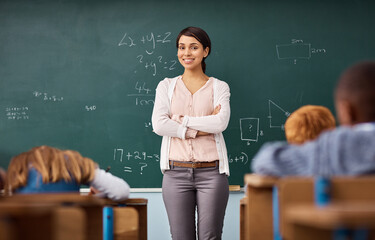 Portrait, woman and teacher in a classroom, arms crossed and education with happiness, employment...