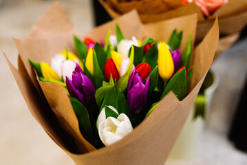 Bouquet of multicolored tulips in a paper bag. A vibrant, close-up of a freshly arranged bouquet...