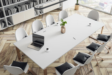 Perspective top view on white conference table with golden vase, modern laptop and coffee mug surrounded by wheel chairs with black cushions in sunlit meeting room with parquet floor. 3D rendering