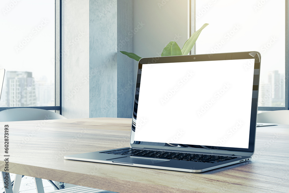 Poster closeup side view of a wooden office desk with white blank screen modern laptop, on city view window