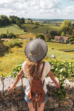 Woman tourist admiring green vineyard in Bordeaux region, Saint Emilion