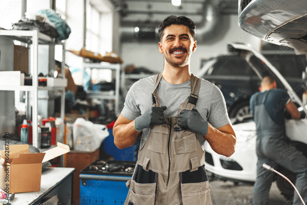 Wall mural Portrait of a male mechanic in an auto repair shop