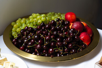 A tray of freshly picked cherries grapes and nectarines from a local garden, ripe with vibrant colors and juicy for healthy eating and wellbeing. Fresh Fruits and berries for Healthy Wellbeing.