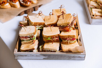 Ready to Eat Variety of Mini Sandwiches on a Wooden Tray