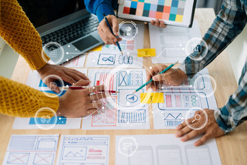  UX developer and ui designer brainstorming about mobile app interface wireframe design with...