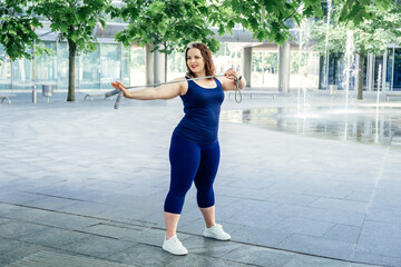Jumping Rope workout. Weight Loss. Plus Size Fitness. Plus size curvy woman exercising outdoor with Jumping Rope.