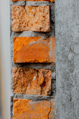 Closeup cracked concrete vintage brick wall.