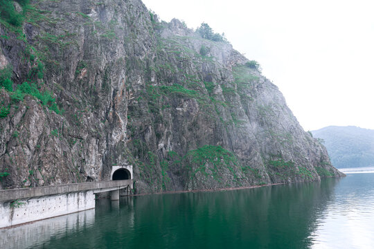 Vidraru Dam Lake in Romania . Foggy scenery with mountains and lake . Vidra Lake  Valcea County Romania.