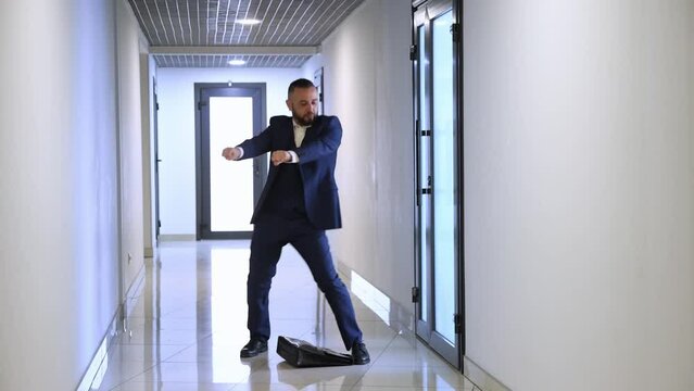 Funny employee walking out boss cabinet and starting emotionally dancing in office lobby. Getting promotion, reaching success. Funny crazy dance. Concept of business, emotions, joy, office, lifestyle
