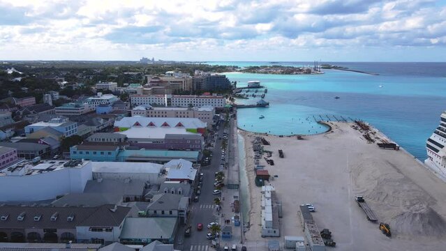 Beautiful cinematic aerial view of the Bahamas - Nassau city - cruise ship port, luxury hotels, buildings, and turquoise water oceans