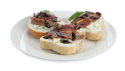 Delicious bruschettas with anchovies, eggs, basil and sauce on white background