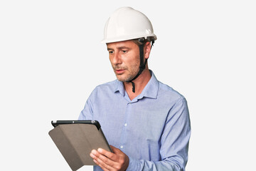 Tech-savvy architect using tablet for work, studio shot.