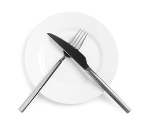 Clean plate with shiny cutlery on white background, top view