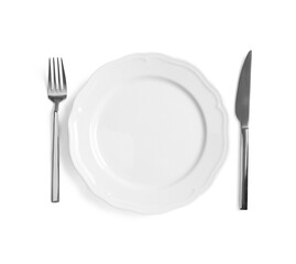 Clean plate and shiny cutlery on white background, top view