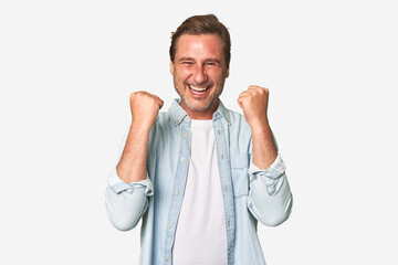 A middle-aged man isolated cheering carefree and excited. Victory concept.