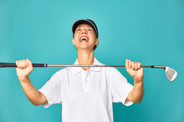 Stylish young woman playing golf in studio