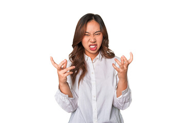 A young chinese woman upset screaming with tense hands.