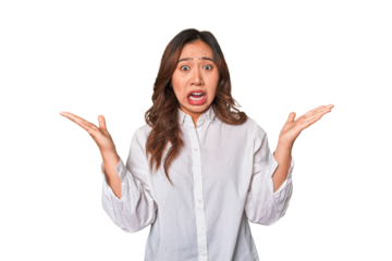 A young chinese woman screaming to the sky, looking up, frustrated.