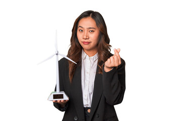 A young Chinese businesswoman proudly holds a windmill, symbolizing her commitment to renewable...