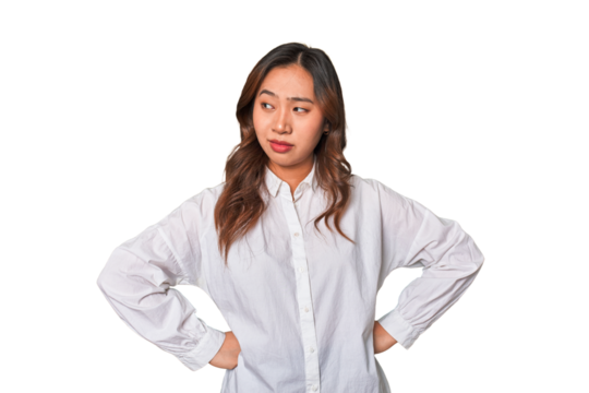 A young chinese woman confused, feels doubtful and unsure.
