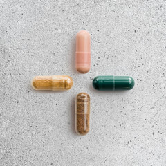 Sports supplements close-up on a light concrete background. Protein, creatine, BCAA capsules, amino...