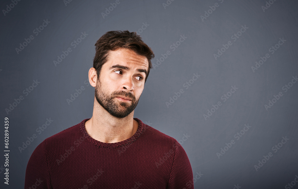 Poster doubt, thinking and face of unsure man in studio with worry, uncertain and thoughtful on gray backgr
