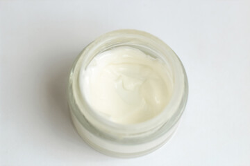 Obraz na płótnie Canvas Moisturizing spf cream in a jar on a light background.
