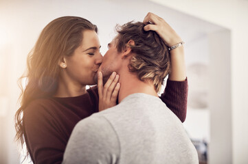Face of happy woman, man and kiss with love in apartment for romance, intimacy and special moment...