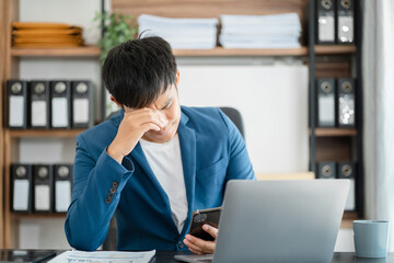 Naklejka premium Young stressed Asian businessman working in the office. Businessman thinking too much work concept in the office.