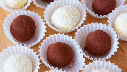 Chocolate and coconut candies. Truffles. macro photography. Abstract background.