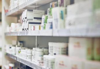 Papier Peint photo Lavable Pharmacie Closeup, pharmacy and medicine with healthcare, pills and shelf with boxes, bottles and treatment. Zoom, medication and package with container, retail and store with pharmaceutical, items or products